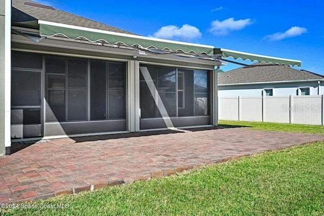 675 Easton Forest Cir SE, Palm Bay, FL 32909 - rear view of property with a patio area and a sunroom
