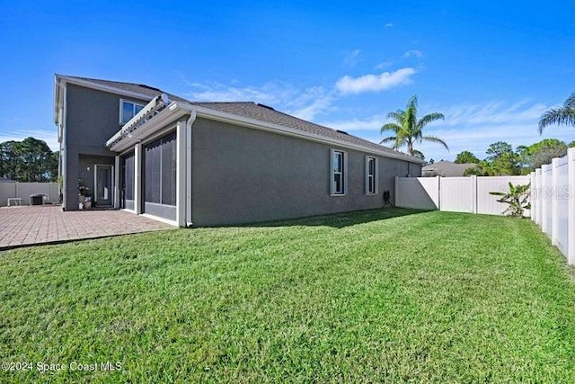 675 Easton Forest Cir SE, Palm Bay, FL 32909 - back of house featuring stucco siding, a patio, a garage, and a sunroom