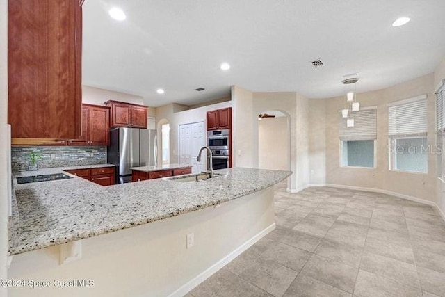 675 Easton Forest Cir SE, Palm Bay, FL 32909 - kitchen with a sink, stainless steel appliances, arched walkways, baseboards, and recessed lighting