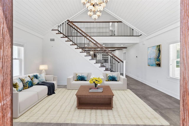 604 Springdale Dr, Flagler Beach, FL 32136 - living room with stairs, plenty of natural light, baseboards, a chandelier, and wood ceiling