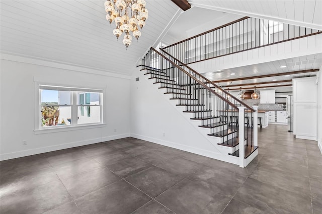 604 Springdale Dr, Flagler Beach, FL 32136 - staircase with a chandelier, concrete flooring, baseboards, and high vaulted ceiling