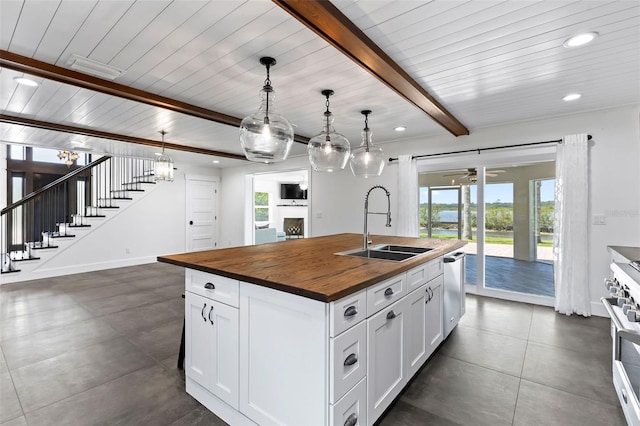 604 Springdale Dr, Flagler Beach, FL 32136 - kitchen with butcher block counters, a sink, healthy amount of natural light, a center island with sink, and recessed lighting