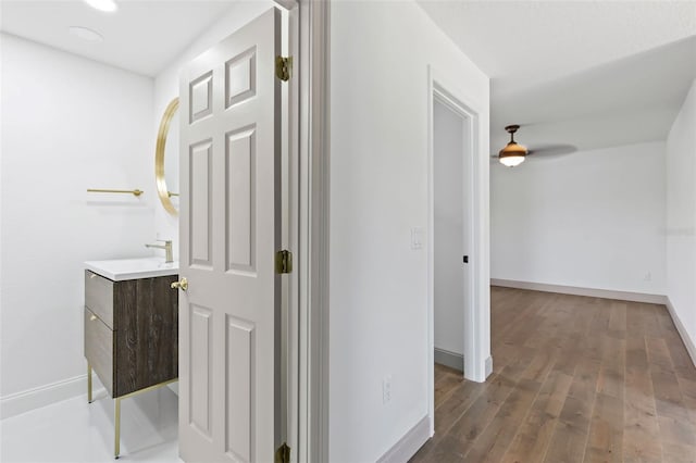 604 Springdale Dr, Flagler Beach, FL 32136 - corridor featuring baseboards, wood finished floors, a sink, and recessed lighting