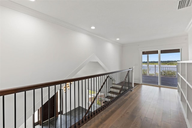 604 Springdale Dr, Flagler Beach, FL 32136 - hall with ornamental molding, wood finished floors, recessed lighting, a water view, and an upstairs landing