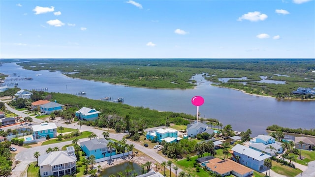 604 Springdale Dr, Flagler Beach, FL 32136 - aerial perspective of suburban area featuring a large body of water and a heavily wooded area