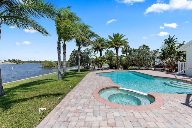 604 Springdale Dr, Flagler Beach, FL 32136 - view of pool featuring a yard, a patio area, a water view, and a pool with connected hot tub