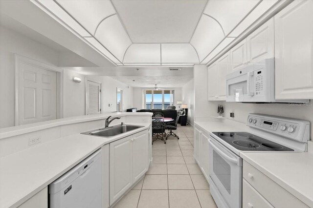 3425 S Atlantic Ave Unit 1602, Daytona Beach, FL 32118 - kitchen with white appliances, a sink, light tile patterned flooring, light countertops, and white cabinets