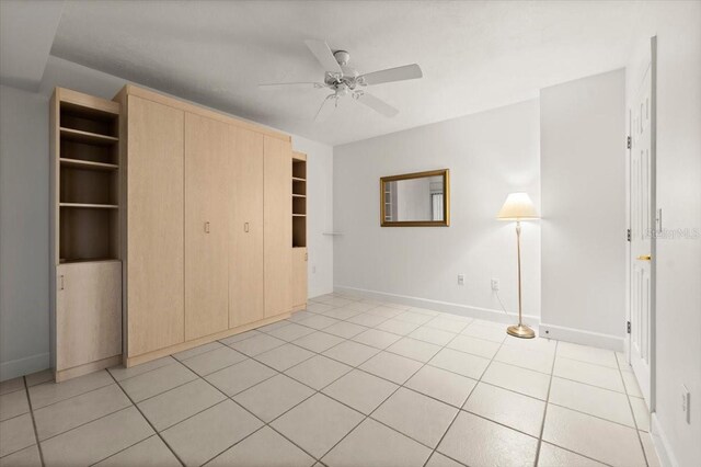 3425 S Atlantic Ave Unit 1602, Daytona Beach, FL 32118 - unfurnished bedroom with light tile patterned floors, baseboards, a closet, and a ceiling fan