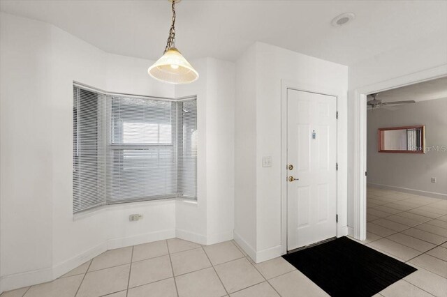 3425 S Atlantic Ave Unit 1602, Daytona Beach, FL 32118 - entryway featuring light tile patterned floors, baseboards, and a ceiling fan