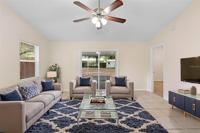 910 Sheeler Oaks Dr, Apopka, FL 32703 - living area featuring lofted ceiling, plenty of natural light, a ceiling fan, light tile patterned floors, and baseboards