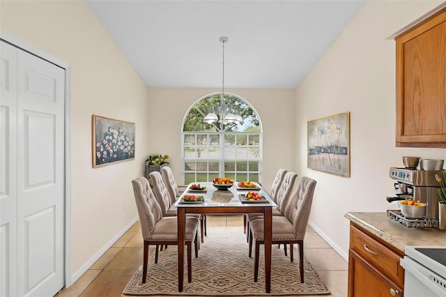 910 Sheeler Oaks Dr, Apopka, FL 32703 - dining room featuring a chandelier, baseboards, and vaulted ceiling