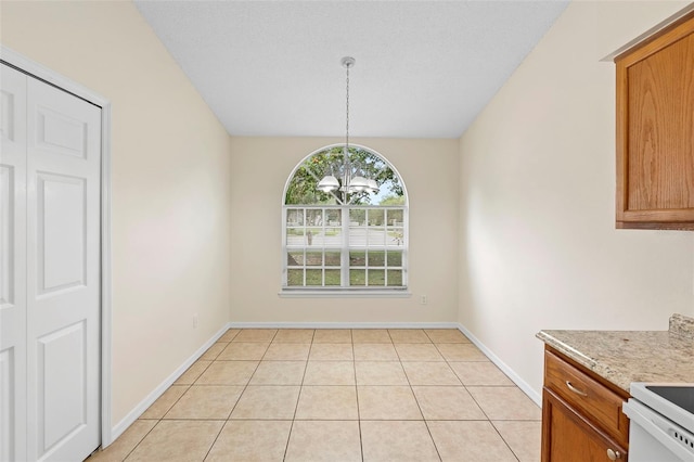 910 Sheeler Oaks Dr, Apopka, FL 32703 - unfurnished dining area featuring a chandelier, baseboards, and light tile patterned flooring