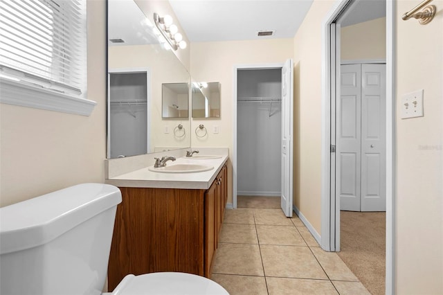 910 Sheeler Oaks Dr, Apopka, FL 32703 - bathroom featuring toilet, double vanity, and tile patterned floors