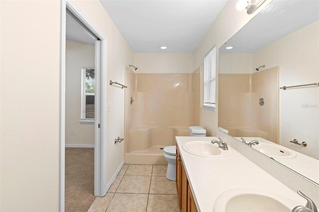 910 Sheeler Oaks Dr, Apopka, FL 32703 - full bathroom with a shower, tile patterned floors, double vanity, toilet, and baseboards