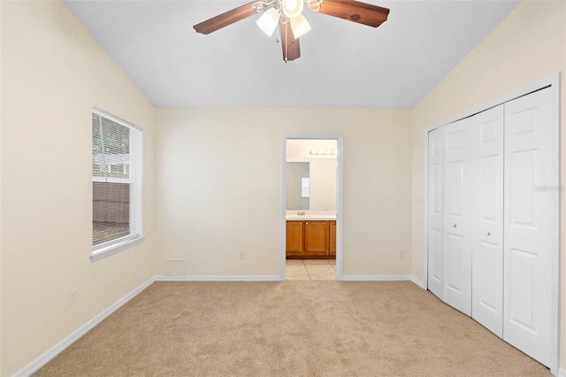 910 Sheeler Oaks Dr, Apopka, FL 32703 - unfurnished bedroom featuring lofted ceiling, light carpet, a closet, baseboards, and ensuite bath