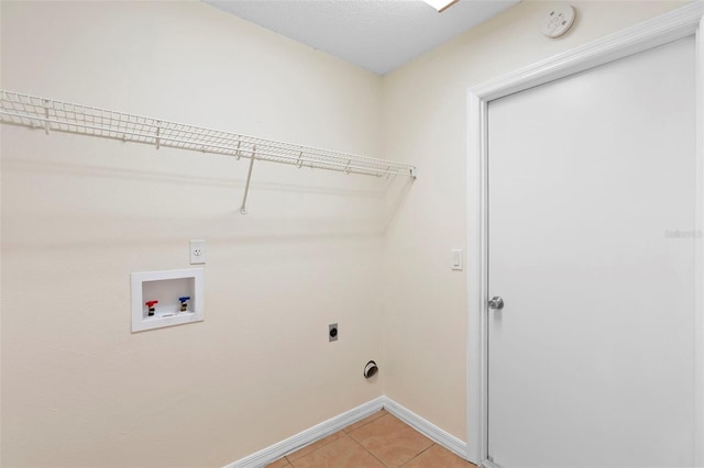910 Sheeler Oaks Dr, Apopka, FL 32703 - laundry area with electric dryer hookup, light tile patterned floors, baseboards, and hookup for a washing machine