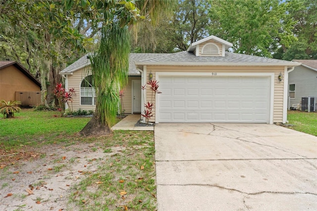 910 Sheeler Oaks Dr, Apopka, FL 32703 - view of front facade featuring a garage, driveway, a shingled roof, central AC unit, and a front lawn