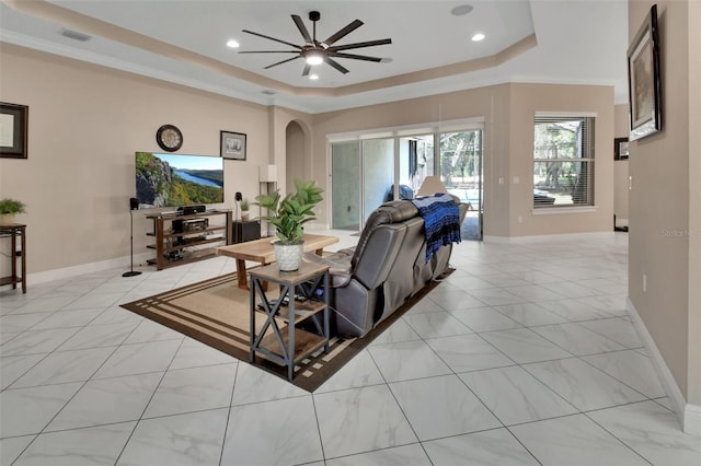 171 Birchmont Dr, Deland, FL 32724 - living area with a tray ceiling, arched walkways, ceiling fan, recessed lighting, and crown molding