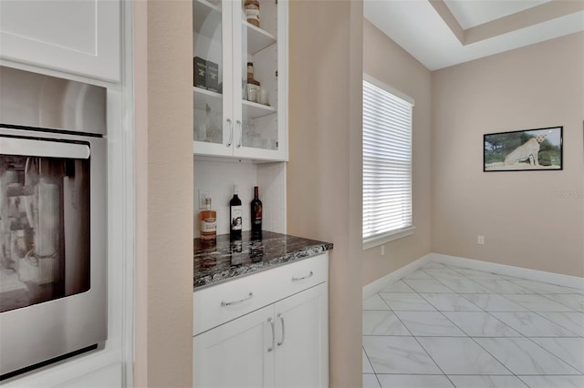 171 Birchmont Dr, Deland, FL 32724 - bar area with stainless steel oven, baseboards, healthy amount of natural light, and light marble finish flooring