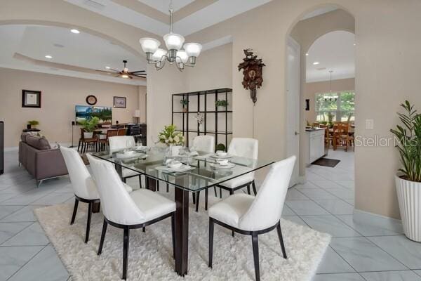 171 Birchmont Dr, Deland, FL 32724 - dining room featuring arched walkways, a ceiling fan, a tray ceiling, light tile patterned floors, and recessed lighting