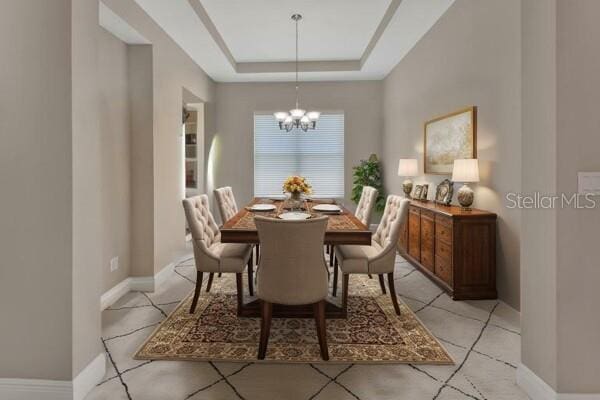 171 Birchmont Dr, Deland, FL 32724 - dining area featuring a chandelier, a raised ceiling, and baseboards