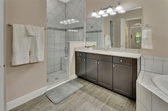171 Birchmont Dr, Deland, FL 32724 - bathroom featuring a stall shower, vanity, wood finished floors, and a tub