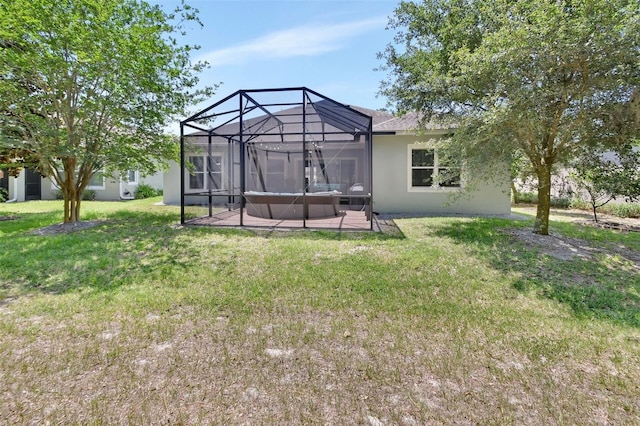 171 Birchmont Dr, Deland, FL 32724 - back of house featuring a patio area, stucco siding, a lawn, and a lanai