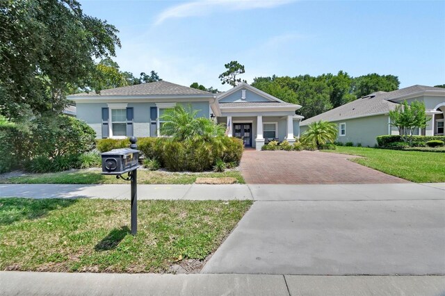 171 Birchmont Dr, Deland, FL 32724 - view of front facade featuring decorative driveway, a front lawn, and stucco siding
