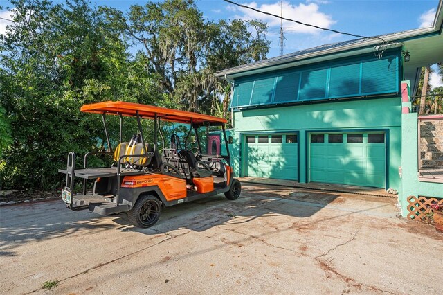 61 E Bayshore Dr, Port Orange, FL 32127 - view of front of property with driveway, a garage, and stucco siding