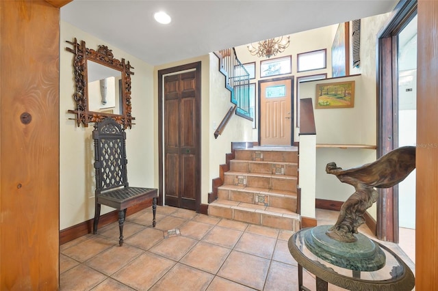 61 E Bayshore Dr, Port Orange, FL 32127 - tiled entryway featuring baseboards, stairway, a chandelier, and recessed lighting
