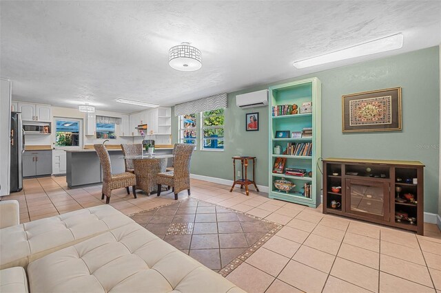 61 E Bayshore Dr, Port Orange, FL 32127 - dining space featuring an AC wall unit, a textured ceiling, light tile patterned flooring, and baseboards