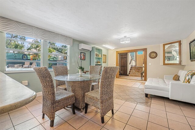 61 E Bayshore Dr, Port Orange, FL 32127 - dining room featuring a wall mounted AC, light tile patterned floors, stairs, and a textured ceiling