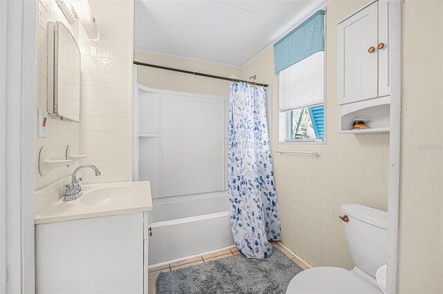 61 E Bayshore Dr, Port Orange, FL 32127 - bathroom featuring tile walls, vanity, shower / bathtub combination with curtain, and toilet
