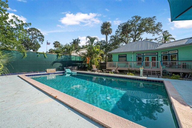 61 E Bayshore Dr, Port Orange, FL 32127 - view of swimming pool with french doors and a wooden deck