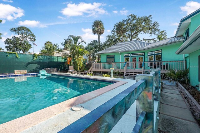 61 E Bayshore Dr, Port Orange, FL 32127 - outdoor pool with a wooden deck and french doors