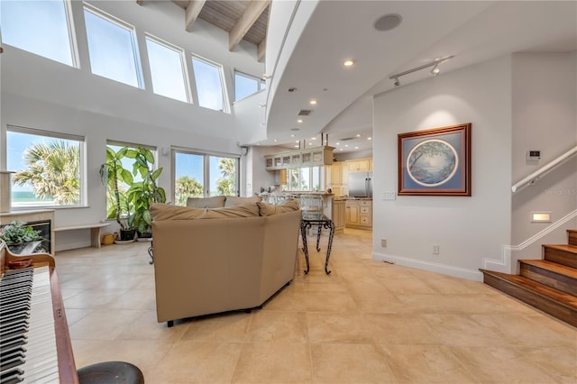 1209 N Atlantic Ave, New Smyrna Beach, FL 32169 - living area with high vaulted ceiling, beamed ceiling, light tile patterned floors, stairway, and recessed lighting