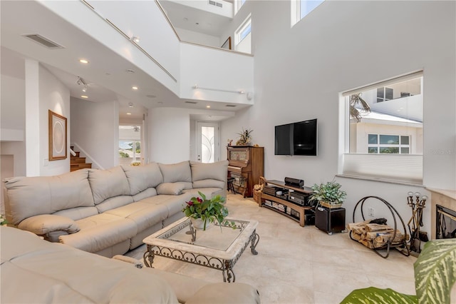 1209 N Atlantic Ave, New Smyrna Beach, FL 32169 - living room featuring a towering ceiling, stairs, and tile patterned floors
