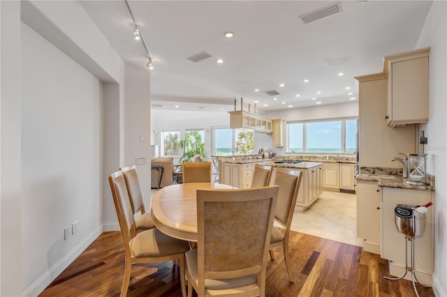 1209 N Atlantic Ave, New Smyrna Beach, FL 32169 - dining room with light wood-style flooring, recessed lighting, and baseboards