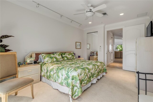 1209 N Atlantic Ave, New Smyrna Beach, FL 32169 - bedroom with ornamental molding, recessed lighting, light colored carpet, a ceiling fan, and a closet