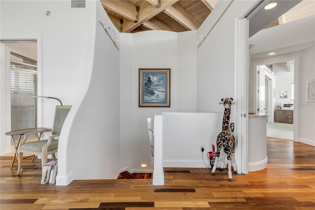 1209 N Atlantic Ave, New Smyrna Beach, FL 32169 - hallway featuring an upstairs landing, wood finished floors, baseboards, wooden ceiling with exposed beams, and recessed lighting