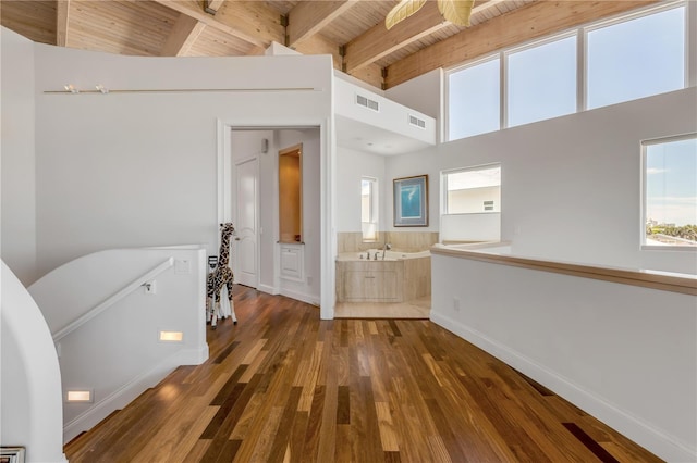 1209 N Atlantic Ave, New Smyrna Beach, FL 32169 - hallway featuring an upstairs landing, wood ceiling with exposed beams, baseboards, plenty of natural light, and wood finished floors