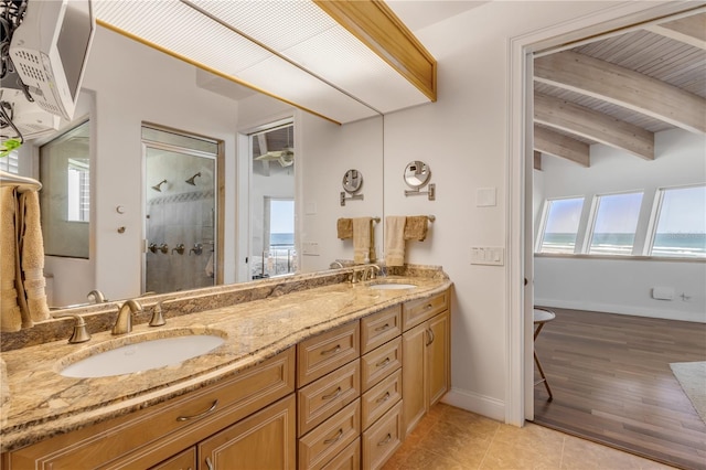 1209 N Atlantic Ave, New Smyrna Beach, FL 32169 - bathroom with double vanity, tiled shower, tile patterned flooring, wood ceiling with exposed beams, and baseboards