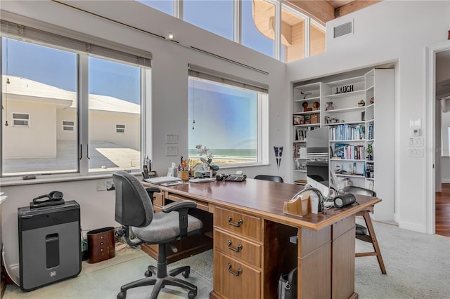 1209 N Atlantic Ave, New Smyrna Beach, FL 32169 - office area featuring a high ceiling, carpet flooring, and beam ceiling