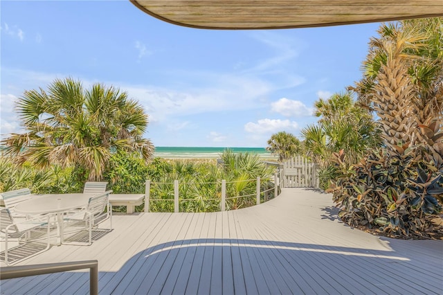 1209 N Atlantic Ave, New Smyrna Beach, FL 32169 - wooden deck with view of water and beach and outdoor dining space