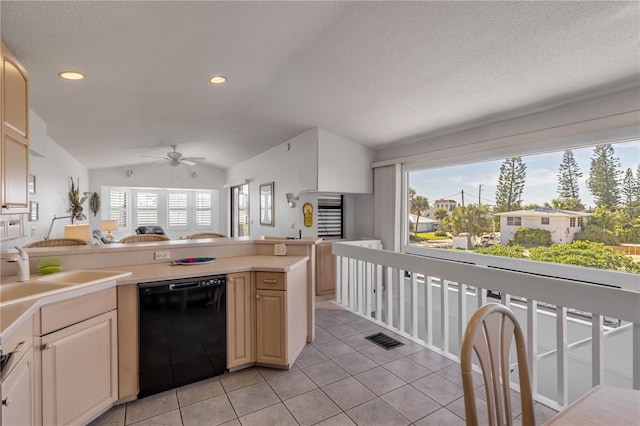 1209 N Atlantic Ave, New Smyrna Beach, FL 32169 - kitchen with dishwasher, vaulted ceiling, a ceiling fan, light tile patterned floors, and light countertops