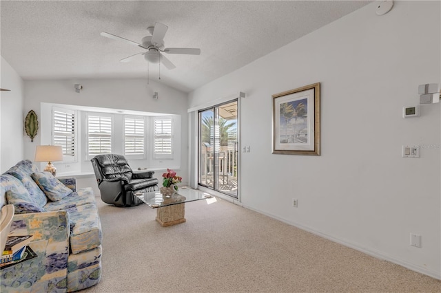 1209 N Atlantic Ave, New Smyrna Beach, FL 32169 - carpeted living area with vaulted ceiling, ceiling fan, a textured ceiling, and baseboards