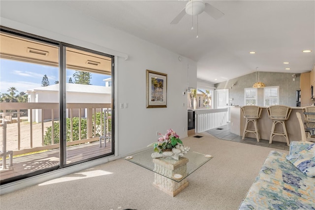 1209 N Atlantic Ave, New Smyrna Beach, FL 32169 - carpeted living room featuring vaulted ceiling, ceiling fan, and recessed lighting