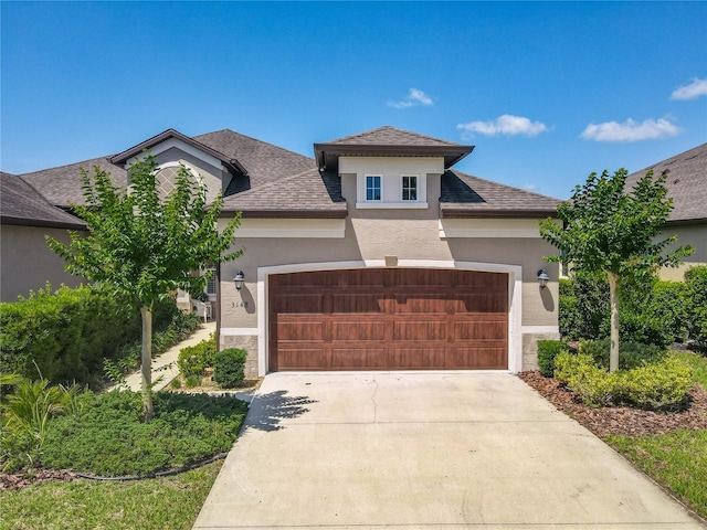 3148 Bailey Ann Dr, Ormond Beach, FL 32174 - view of front facade with stucco siding, an attached garage, driveway, and a shingled roof