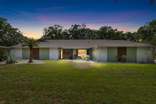 4301 Hudson Ln, Tampa, FL 33618 - view of front of property with a yard and stucco siding
