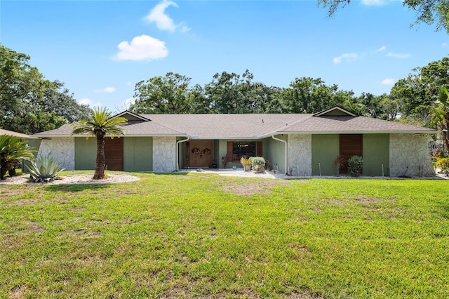 4301 Hudson Ln, Tampa, FL 33618 - view of front facade featuring a front lawn, stone siding, and stucco siding